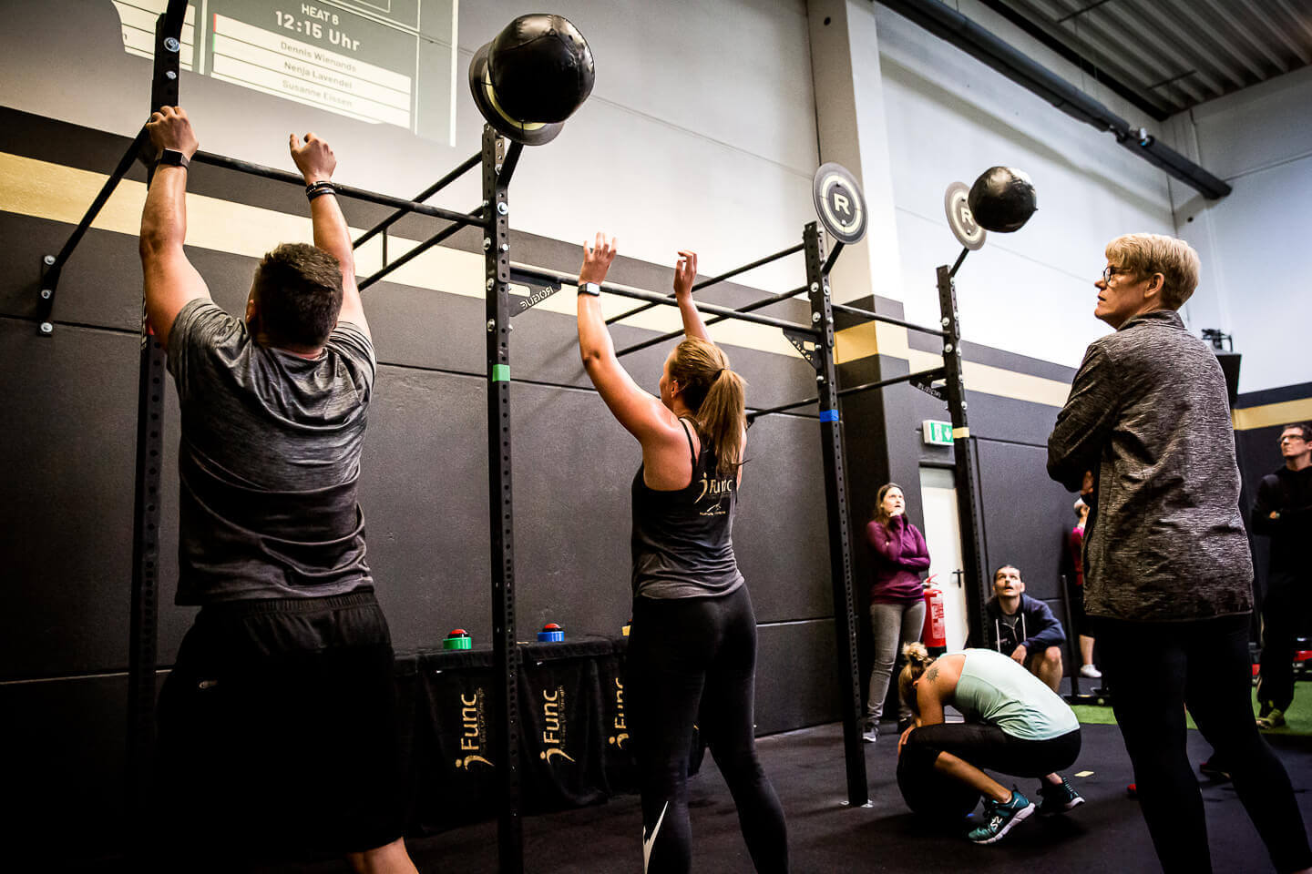 Executing wallballs and a visible scoreboard.